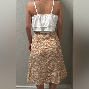 Two pieces with a white crop top and a orange floral skirt